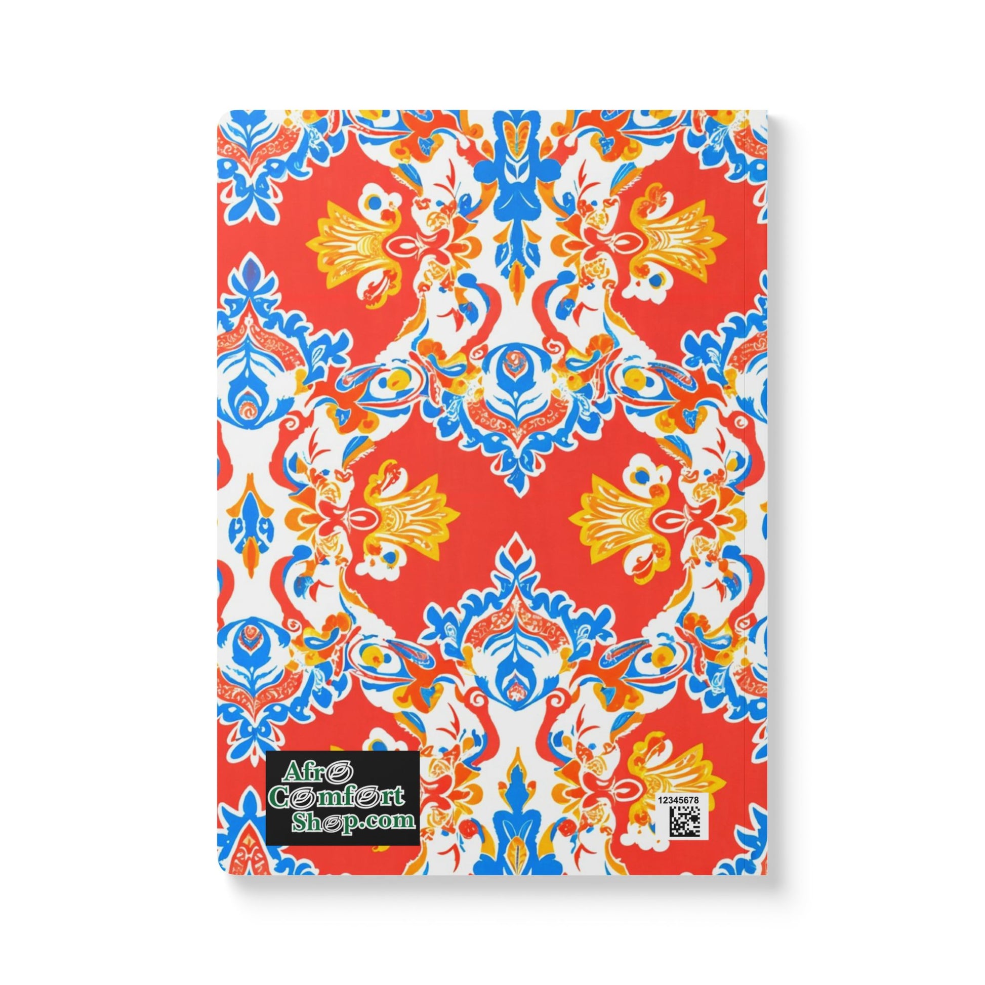 A vibrant African-inspired journal featuring a red, blue, yellow, and white symmetrical floral pattern. The cover includes a green and black AfroComfortShop.com label and a QR code sticker in the lower left corner. Perfect for daily journaling.