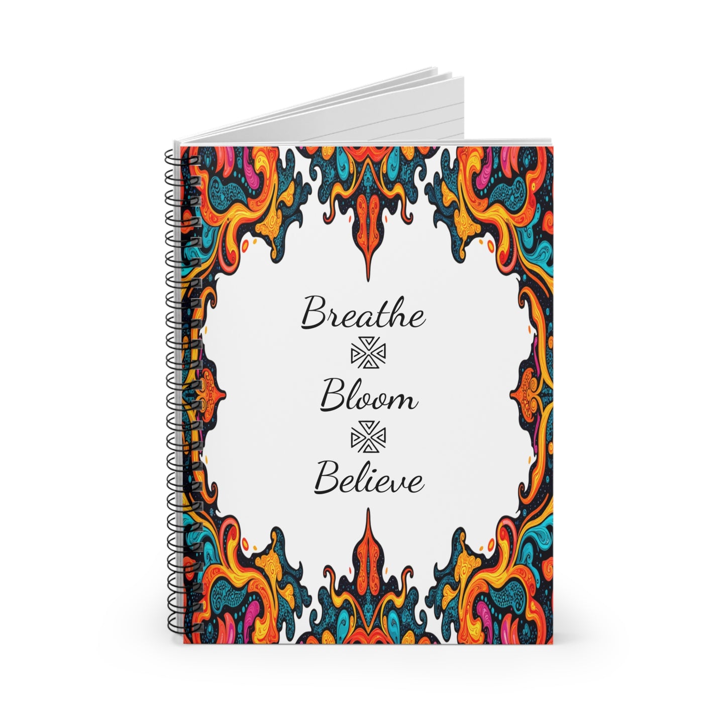 A spiral notebook with lined pages, featuring a white cover adorned by colorful, intricate paisley and African geometric patterns. The center showcases handwritten words: Breathe, Bloom, and Believe, stacked with decorative symbols between them.