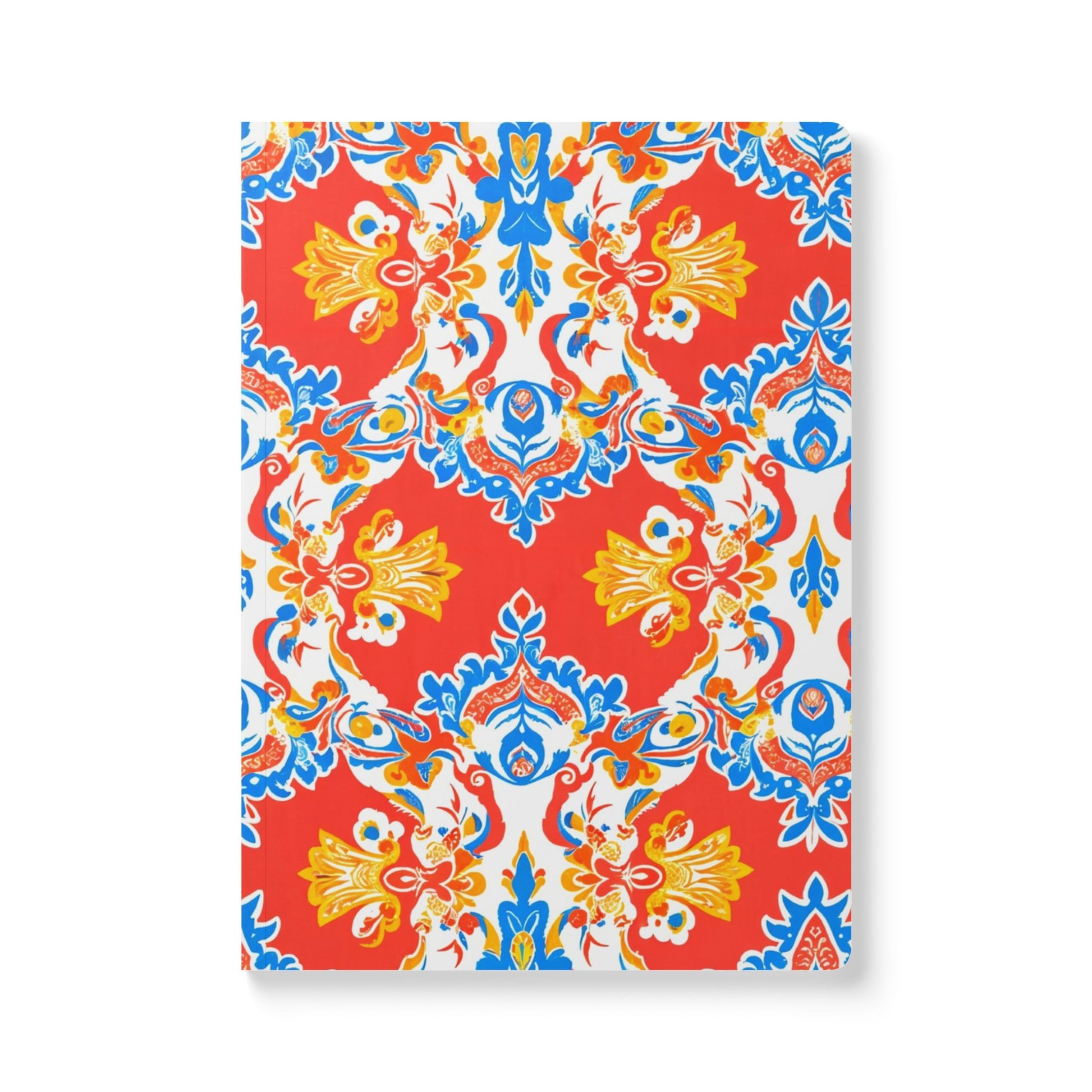A creative journal with a vibrant, symmetrical floral pattern in red, blue, yellow, and white. The bold design features ornate flowers and leaves, creating a lively motif on the cover—perfect for daily journaling or as an African-inspired journal.