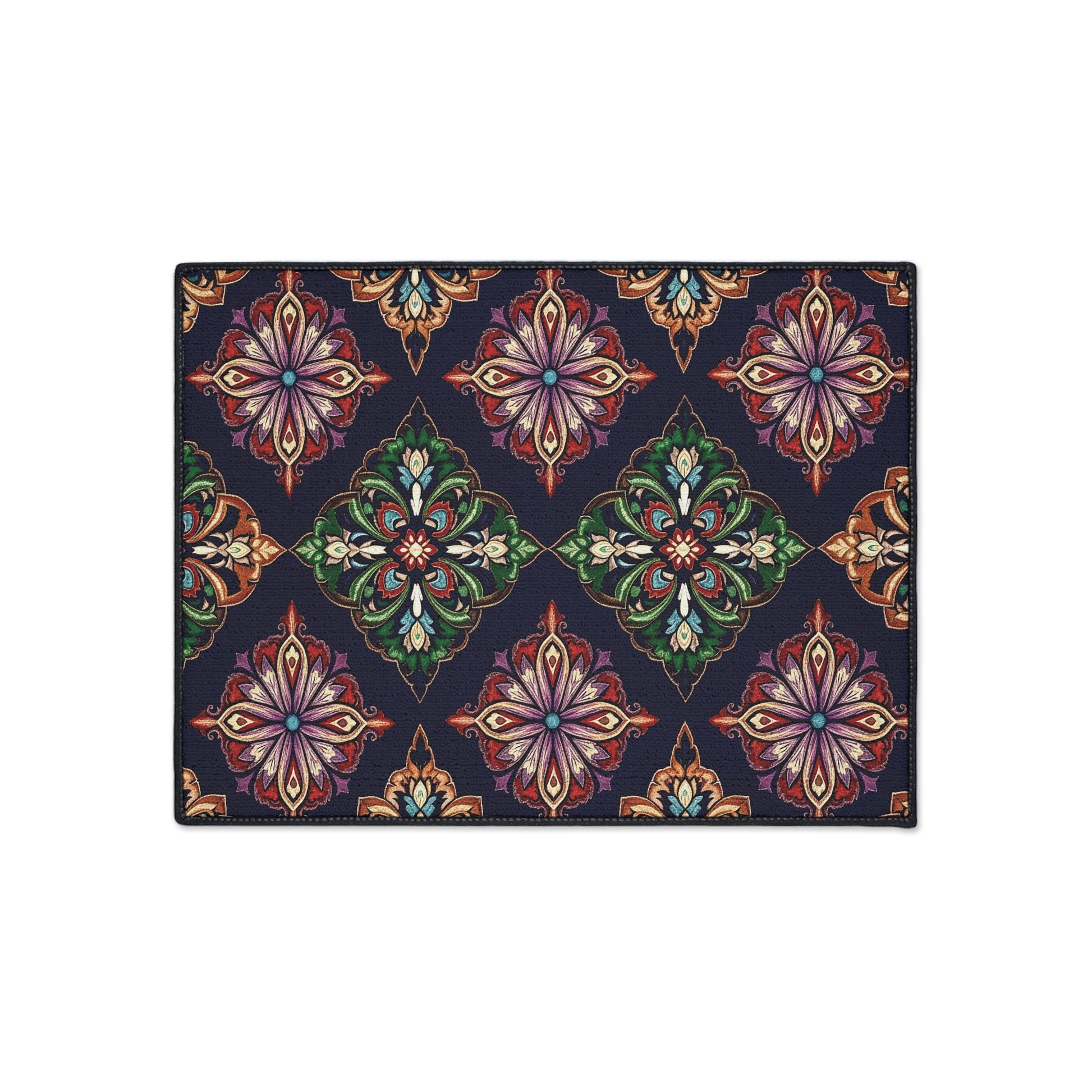 Rectangular rug with an African-inspired, repeating geometric floral pattern. Ornate, symmetrical motifs in green, red, purple, orange, and beige on a dark navy blue background create a vibrant look. Features non-slip rubber backing for added safety.