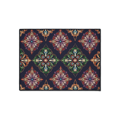 Rectangular rug with an African-inspired, repeating geometric floral pattern. Ornate, symmetrical motifs in green, red, purple, orange, and beige on a dark navy blue background create a vibrant look. Features non-slip rubber backing for added safety.