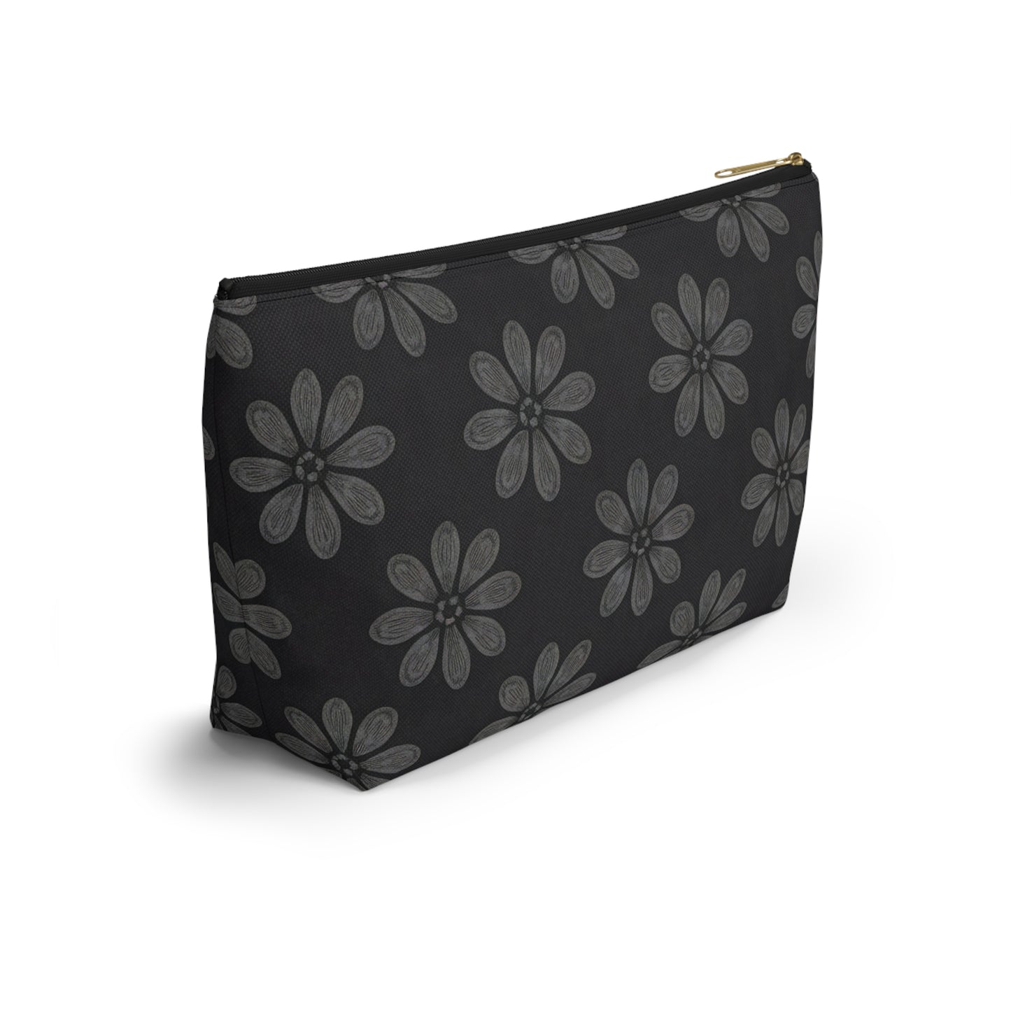 A black T-bottom pouch with a gold zipper, featuring a repeating pattern of large, hand-drawn gray flowers with six petals each. The cosmetic travel bag stands upright on a white background, casting a faint shadow.