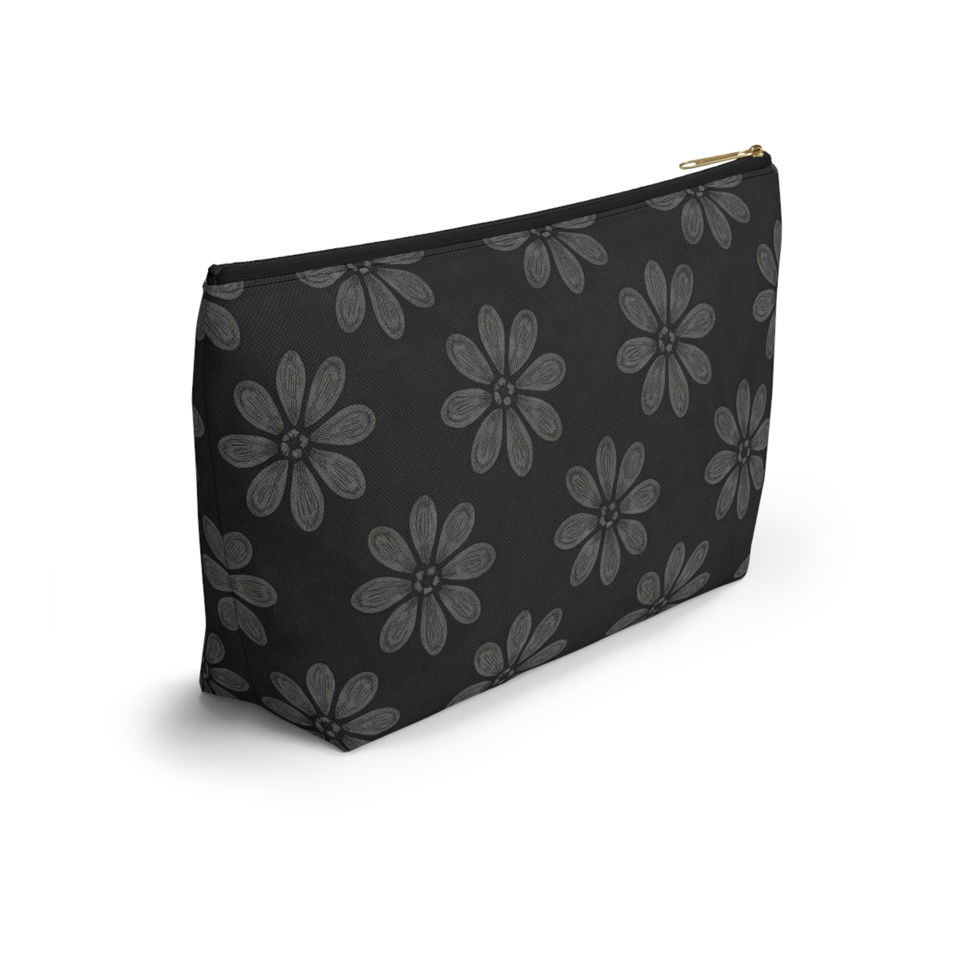 A black T-bottom pouch with a gold zipper, featuring a repeating pattern of large, hand-drawn gray flowers with six petals each. The cosmetic travel bag stands upright on a white background, casting a faint shadow.