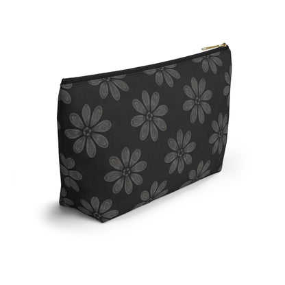 A black T-bottom pouch with a gold zipper, featuring a repeating pattern of large, hand-drawn gray flowers with six petals each. The cosmetic travel bag stands upright on a white background, casting a faint shadow.