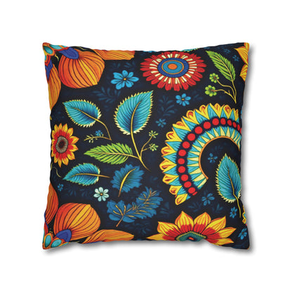 A square pillow with a dark background, featuring vibrant African-inspired patterns in orange, yellow, teal, red, and blue. Large stylized flowers, leaves, and decorative motifs create a bold and lively appearance reminiscent of African pillowcases.