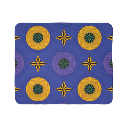 A rectangular sherpa fleece blanket with a blue background features a repeating geometric pattern of yellow and green circular shapes and gold star-like designs, arranged in a grid—perfect for adding cozy home decor with African-inspired flair.