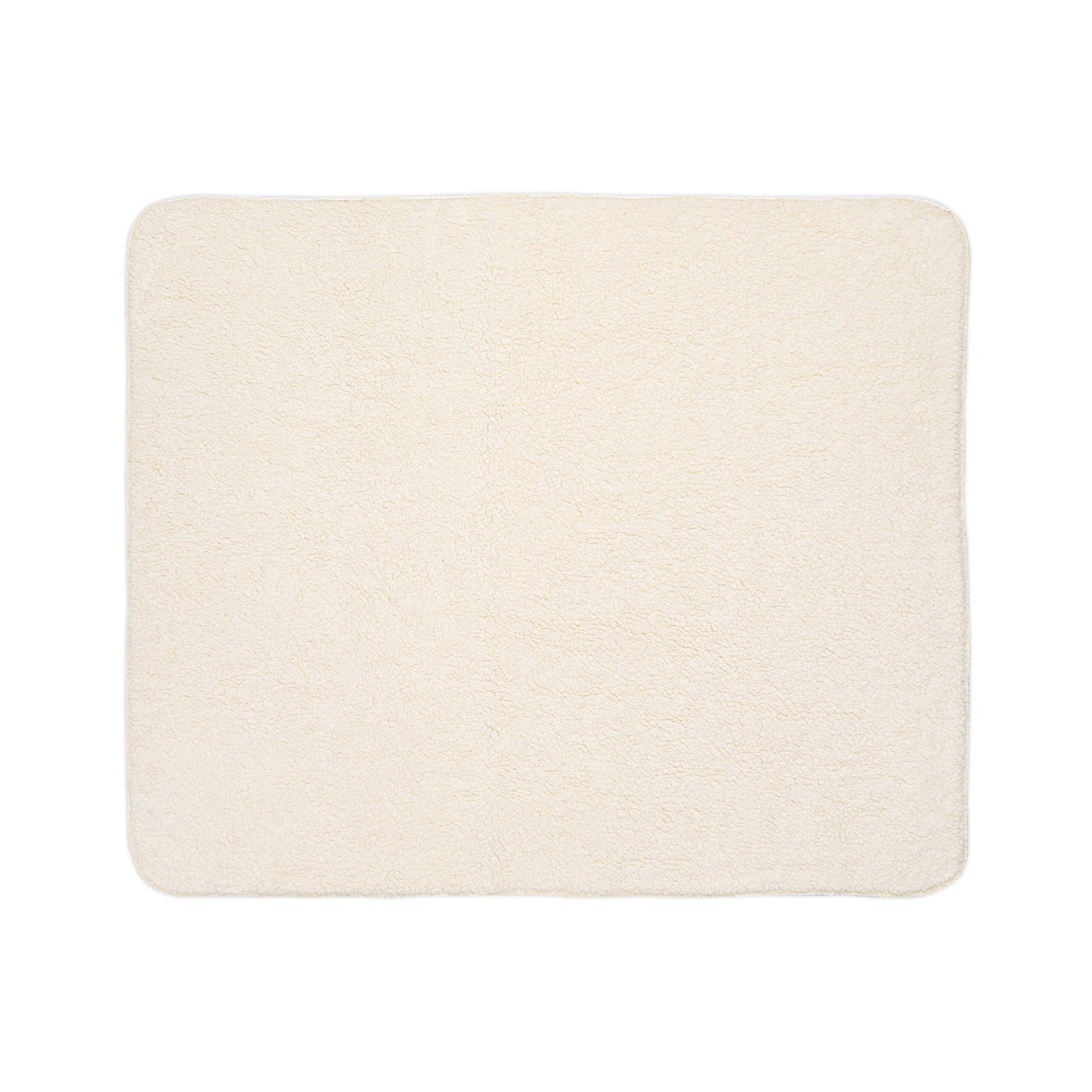 A rectangular, cream-colored, plush bath mat with softly rounded corners and a uniform, fluffy texture is shown against a white background. Its cozy look is enhanced by subtle African-inspired detailing for a unique touch.