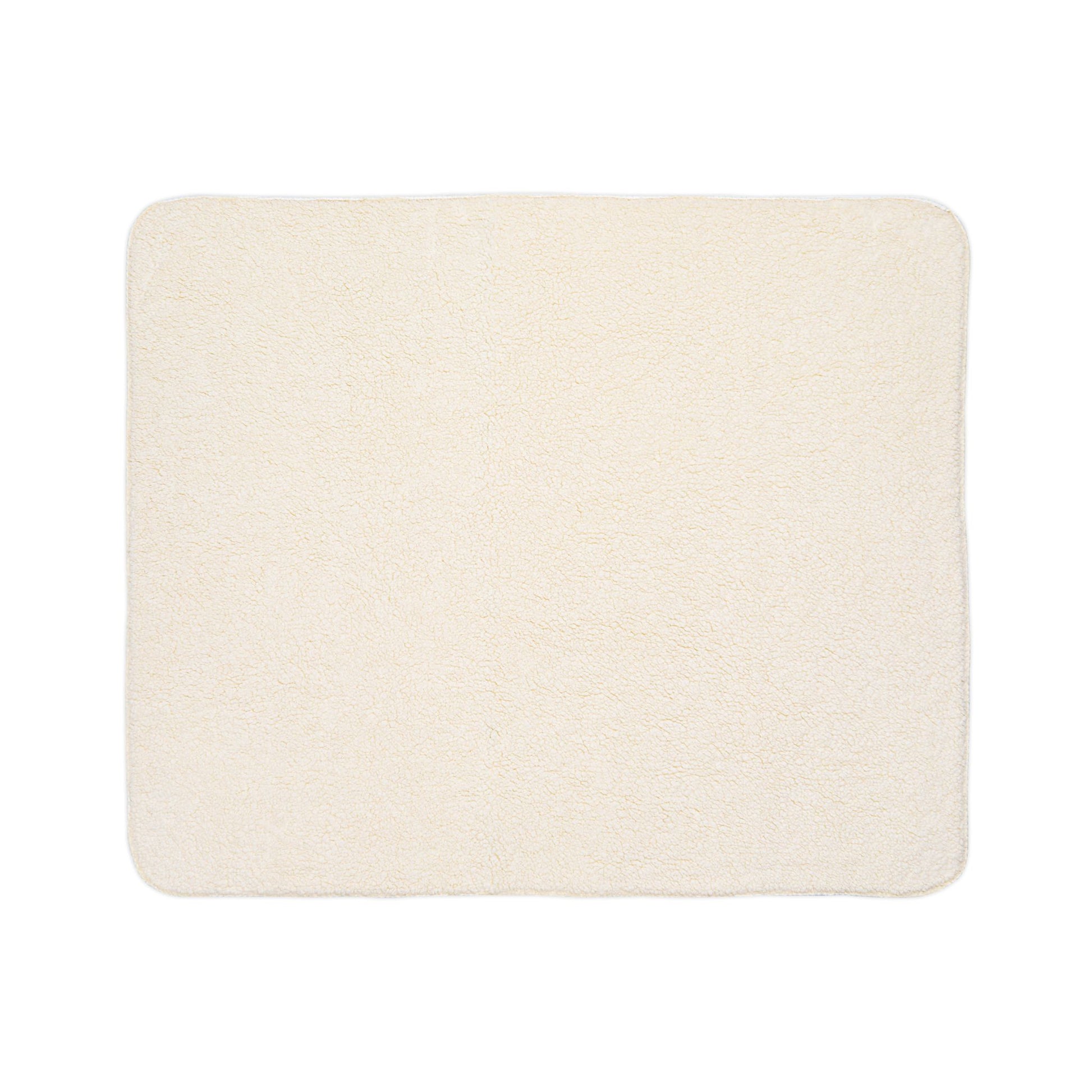 A rectangular, cream-colored, plush bath mat with softly rounded corners and a uniform, fluffy texture is shown against a white background. Its cozy look is enhanced by subtle African-inspired detailing for a unique touch.