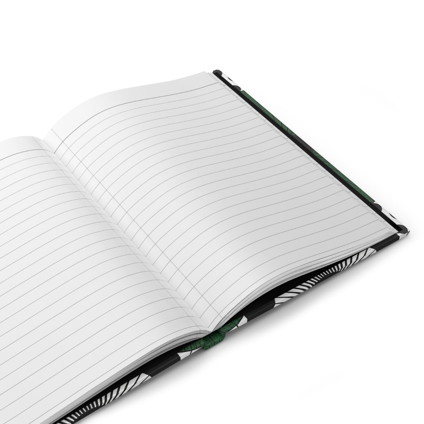A close-up of an open hardcover journal with lined white pages. The cover has a black and white abstract pattern, and a green ribbon bookmark is visible in the center crease. The notebook rests on a white surface.