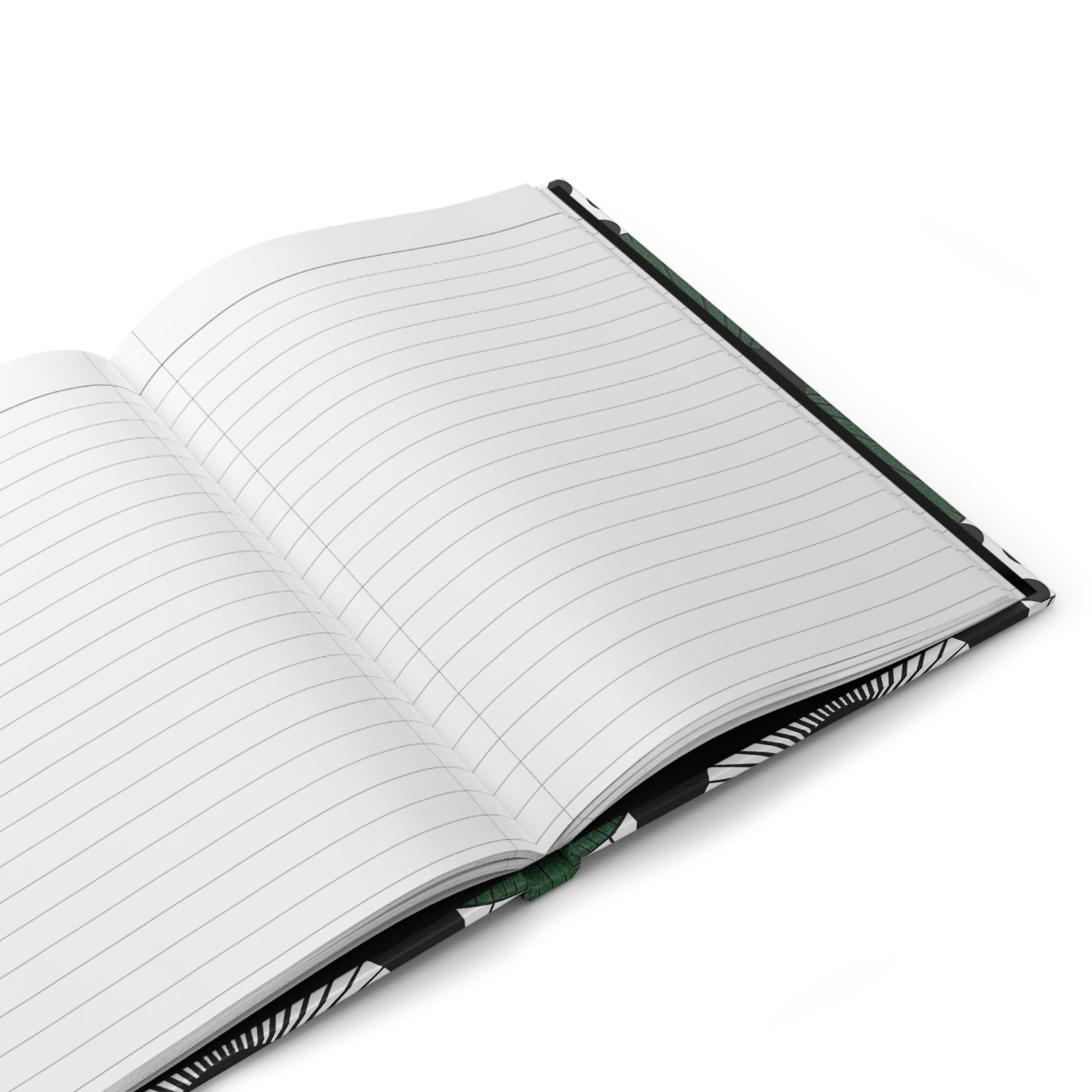 A close-up of an open hardcover journal with lined white pages. The cover has a black and white abstract pattern, and a green ribbon bookmark is visible in the center crease. The notebook rests on a white surface.