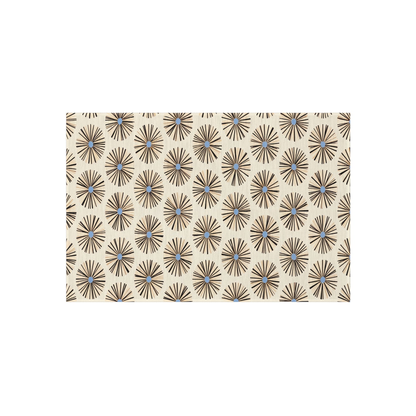 A beige rectangular surface features a repeating pattern of black starburst shapes with light blue centers, inspired by authentic African art designs. The geometric, mid-century modern look is enhanced by weather-resistant polyester chenille.