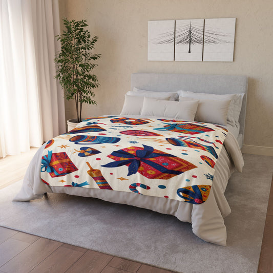 A cozy bedroom features an African-inspired fleece blanket decorated with colorful gift boxes, mugs, candy canes, and stars. The room has light walls, a potted plant, sheer curtains, and minimalist art above the headboard—perfect home decor.
