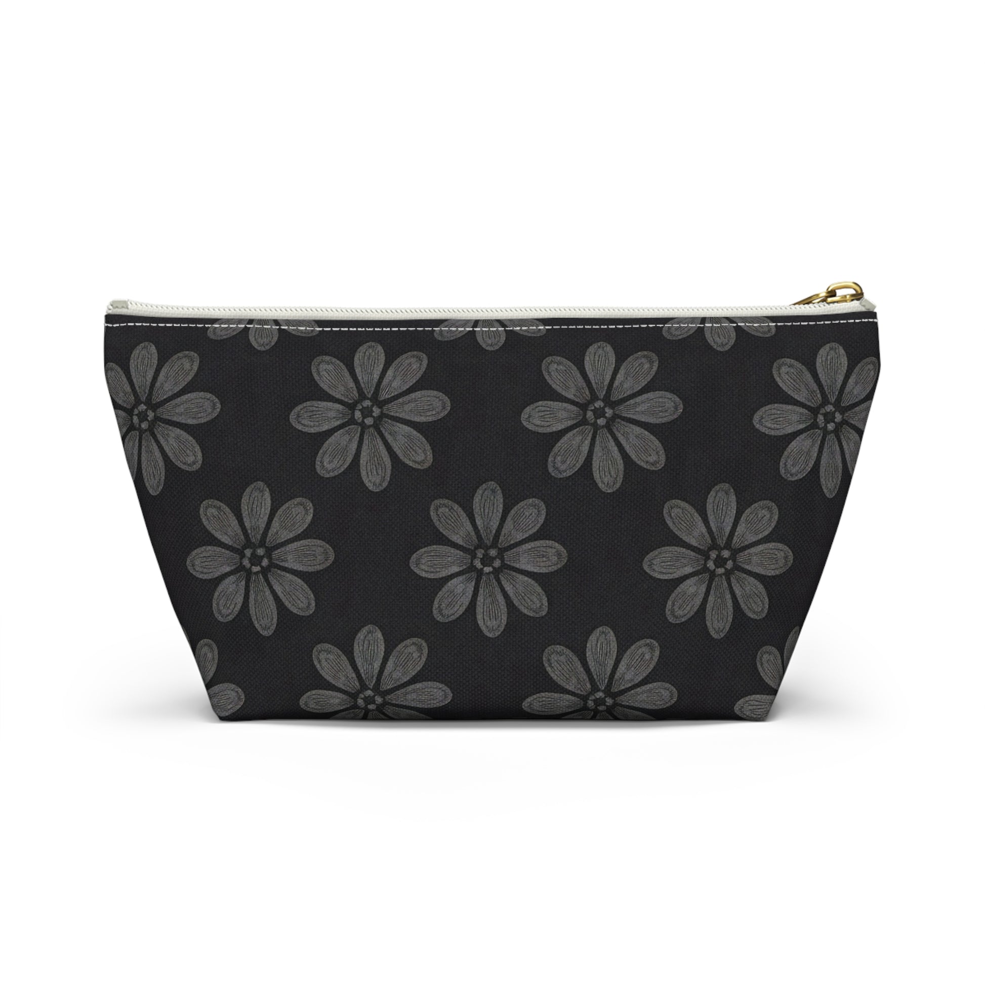A zippered T-bottom pouch with a black background features a repeating pattern of large, stylized gray flowers with six petals each. The white zipper has a gold pull tab. Perfect as a cosmetic travel bag, it’s displayed against a plain white backdrop.