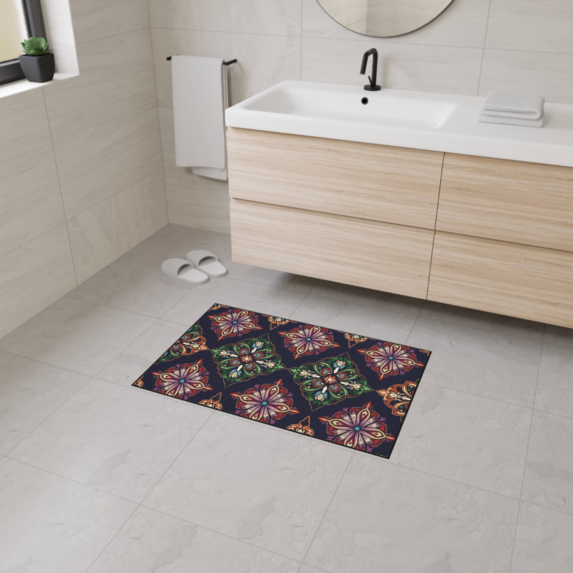 A modern bathroom with light gray tiles, a wooden vanity, round mirror, and a custom floor mat featuring African-inspired aesthetics—intricate floral and geometric patterns on a dark background—with non-slip rubber backing for safety.