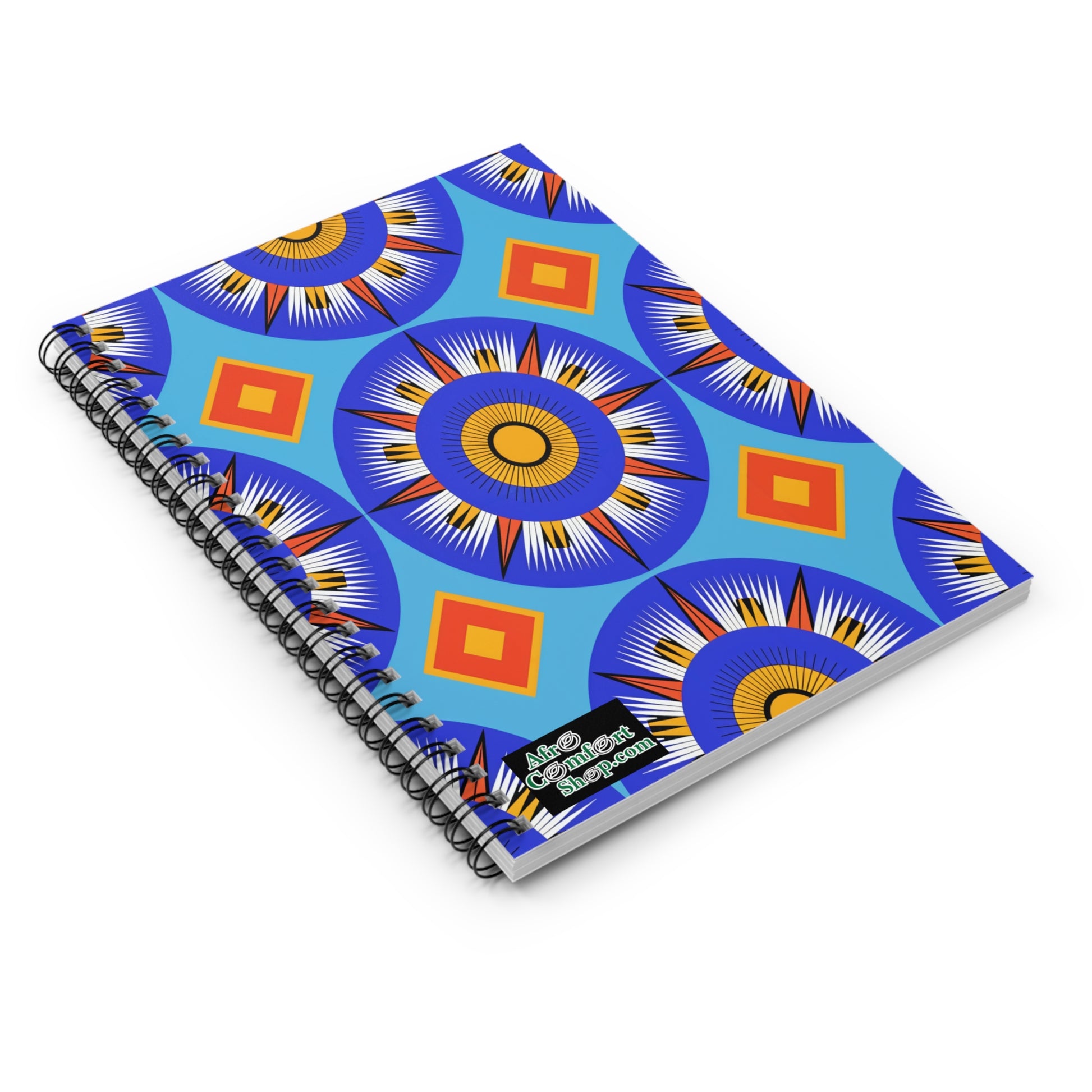 A spiral-bound African-inspired spiral notebook with a bright blue cover featuring bold, geometric patterns of concentric circles and diamond shapes. The lower right corner displays a small “Afro Conscious Creations” logo in white and green.