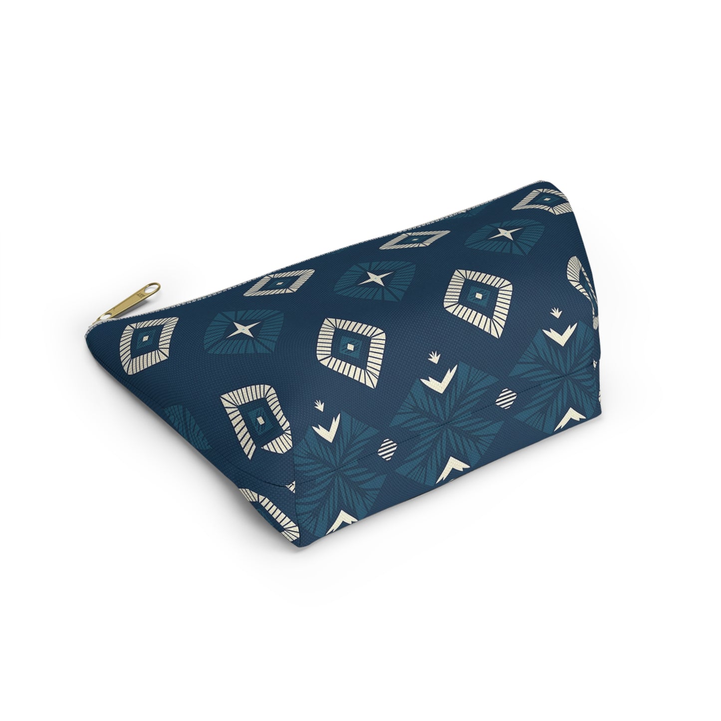 A navy blue T-bottom pouch with a gold zipper, featuring a geometric pattern of cream and light blue shapes, including diamonds and starburst designs inspired by African-inspired patterns. The cosmetic travel bag is displayed against a white background.