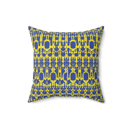 Square pillow with a blue and yellow geometric pattern. The symmetrical design features repeating shapes and intricate details, resembling an African accent pillow. Photographed against a plain white background.