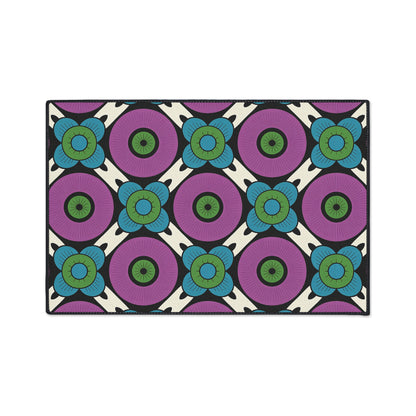 A bold, retro patterned rug with large purple circles and green centers, accented by blue and green floral shapes on a white and black grid. Inspired by African-inspired rugs, this design features non-slip backing for added safety.
