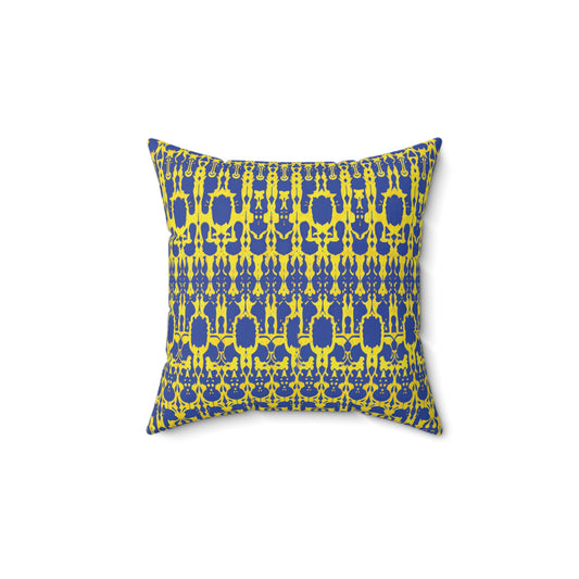 A square faux suede pillow with a vibrant yellow and blue symmetrical pattern. The design features repeating abstract shapes and motifs, creating a bold and modern African inspired accent pillow centered on a white background.