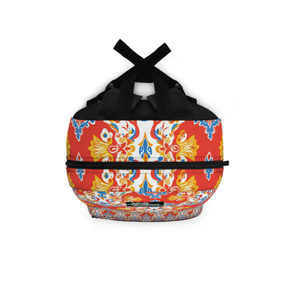 This boho chic rucksack features black handles and straps, adorned with a vibrant pattern of yellow, blue, and red ornate floral and geometric designs on a white and red background, creating a symmetrical look that covers the entire bag.