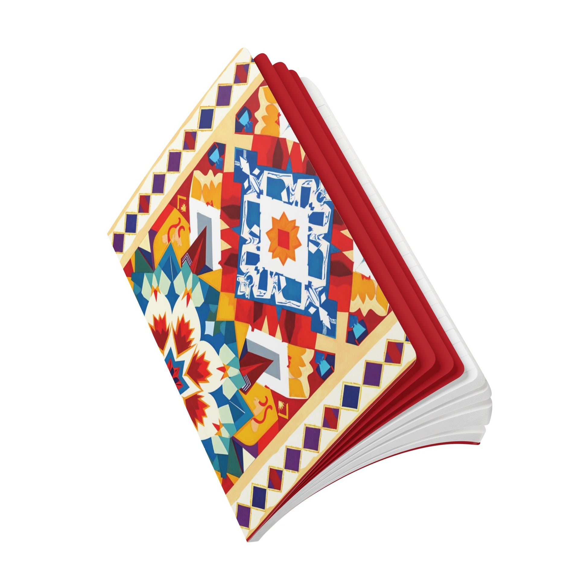 A colorful, open African-inspired journal with a vibrant geometric and floral cover in reds, blues, yellows, and whites. The symmetrical designs invite daily journaling. The pages are mostly white, with bright red inside covers against a plain white background.