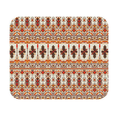 A rectangular mat with rounded corners features a symmetrical, intricate folk pattern in red, orange, gold, and brown. This African-inspired mouse pad displays stylized leaves and geometric shapes on cream, offering a vibrant desk accessory with a non-slip rubber base.