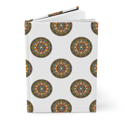 A hardcover journal with a white cover featuring a repeating pattern of intricate, colorful circular mandalas in orange, blue, yellow, and black. The book is slightly open and stands against a plain white background.