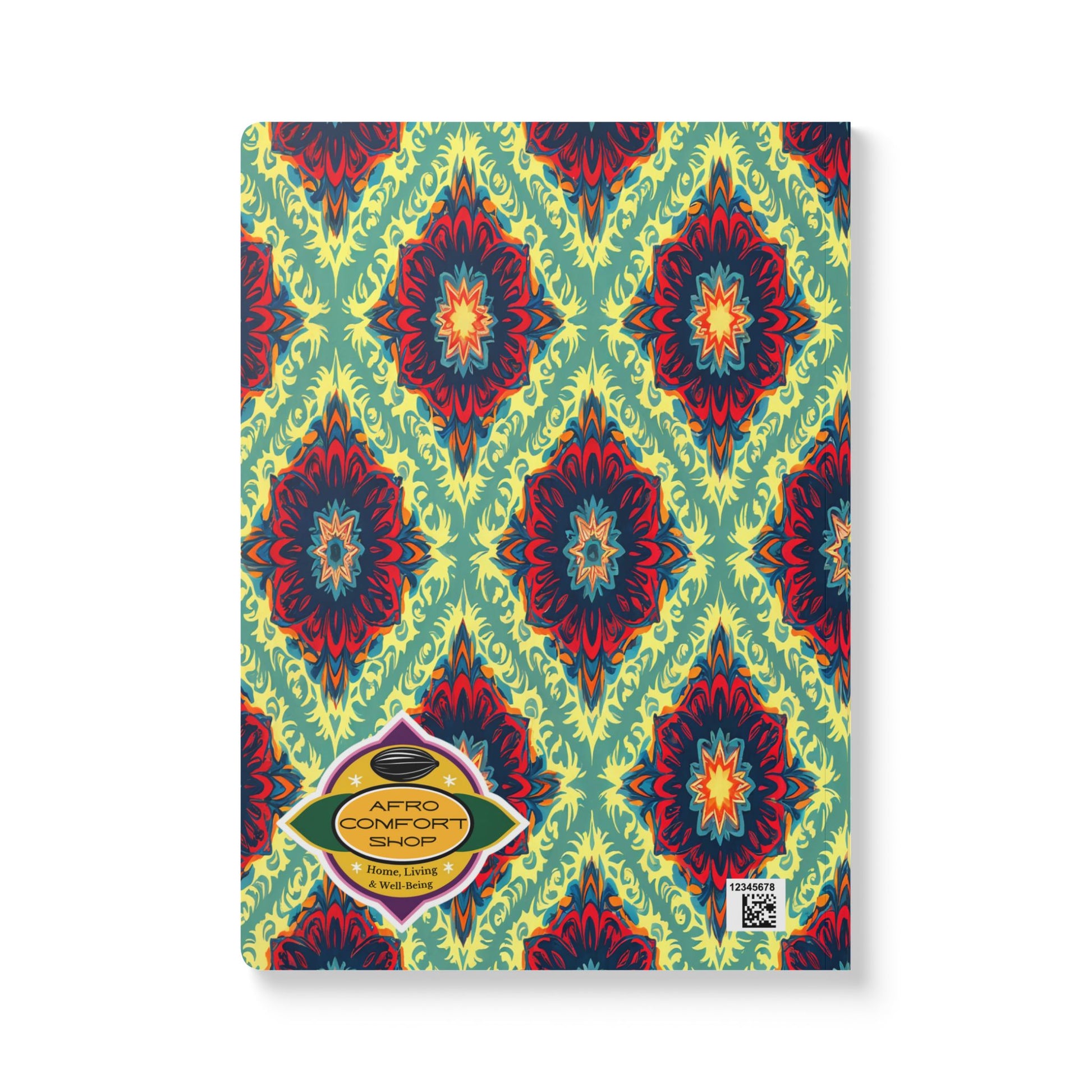 A creative notebook with a vibrant geometric pattern in red, blue, and yellow on a green background. A yellow label with “AFRO COMFORT SHOP” and a QR code are on the bottom left corner of this African-inspired journal.