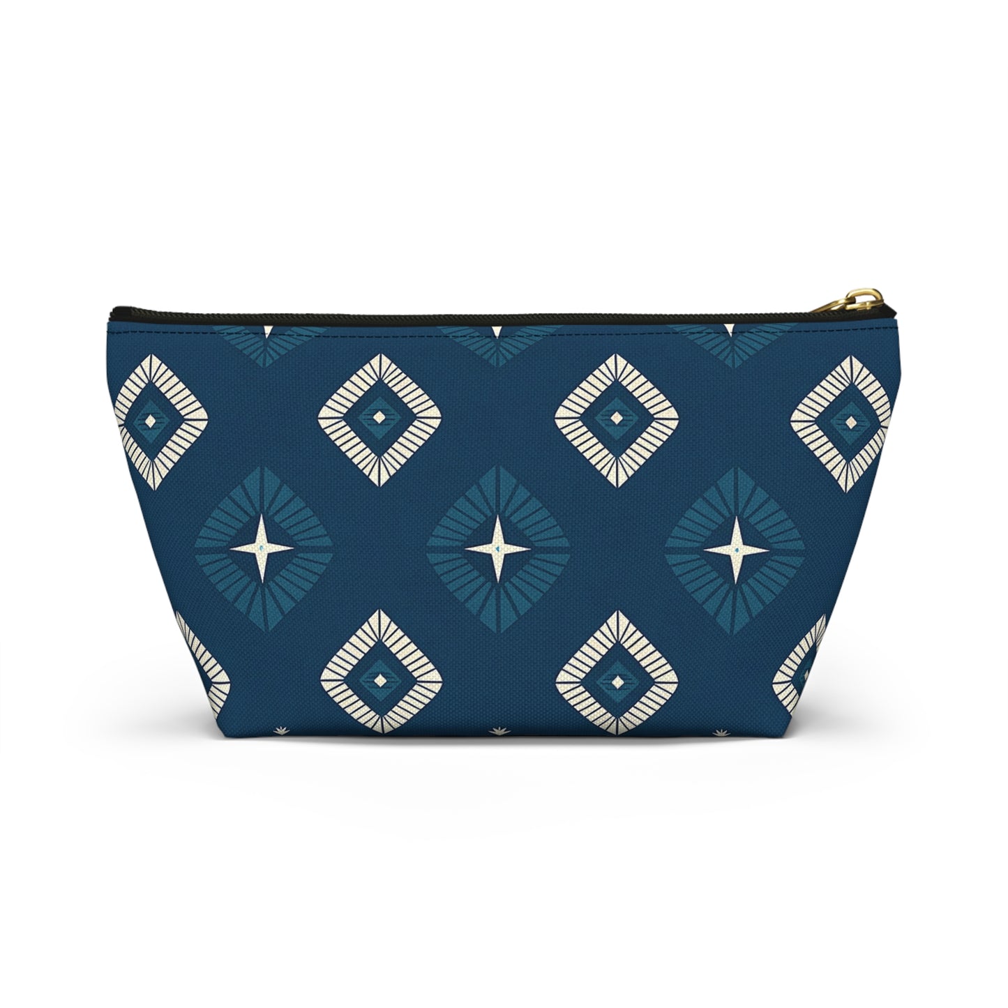 A T-bottom pouch with a geometric diamond pattern in teal, navy blue, and white. The African-inspired patterns feature starburst centers and radiating lines on a deep blue background. Gold zipper hardware lets this cosmetic travel bag stand upright.