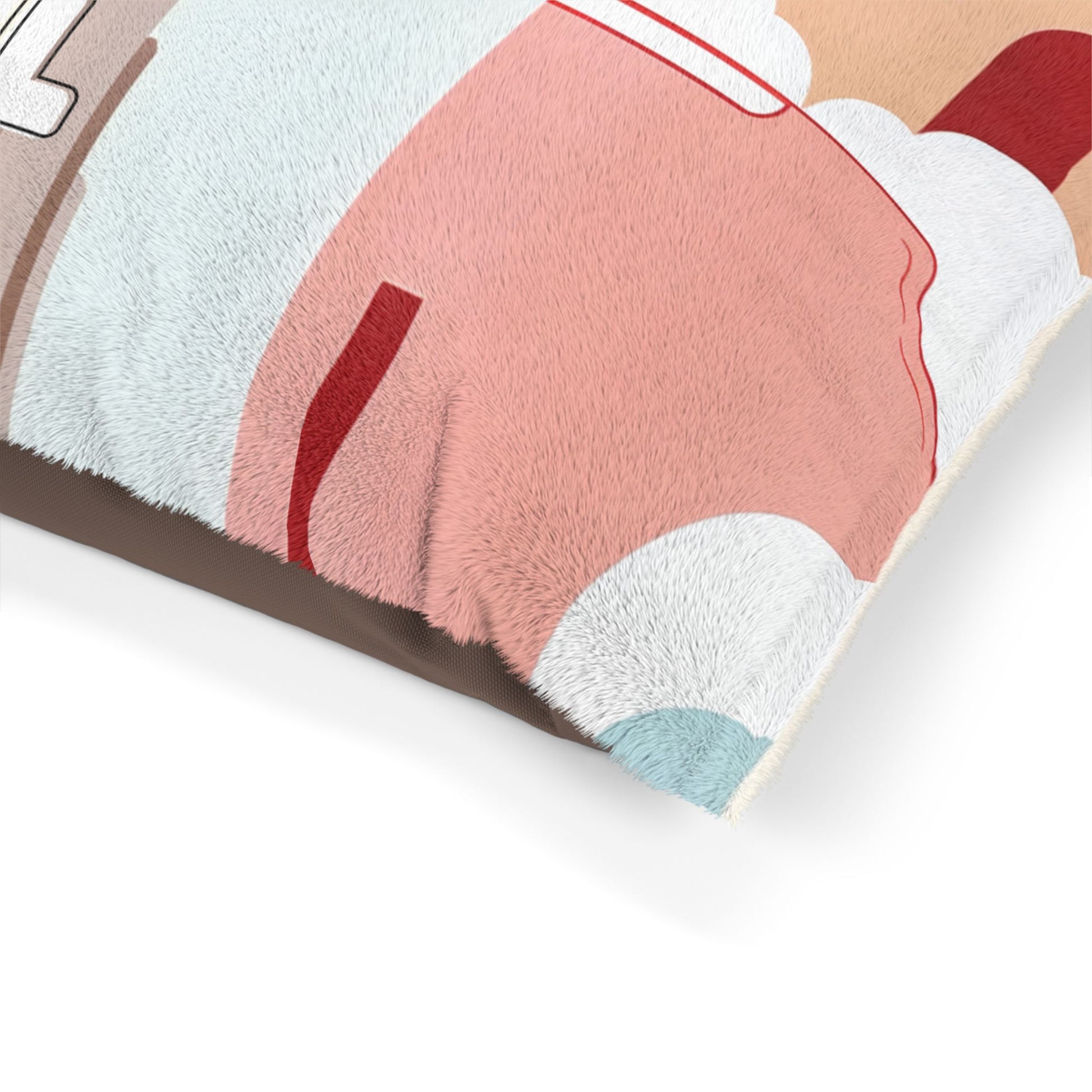 Close-up of a soft, furry pillow with an African-inspired abstract design featuring pastel pink, tan, blue, white, and red shapes and lines. The pillow is angled on a white surface, highlighting its fluffy texture and edge seams.