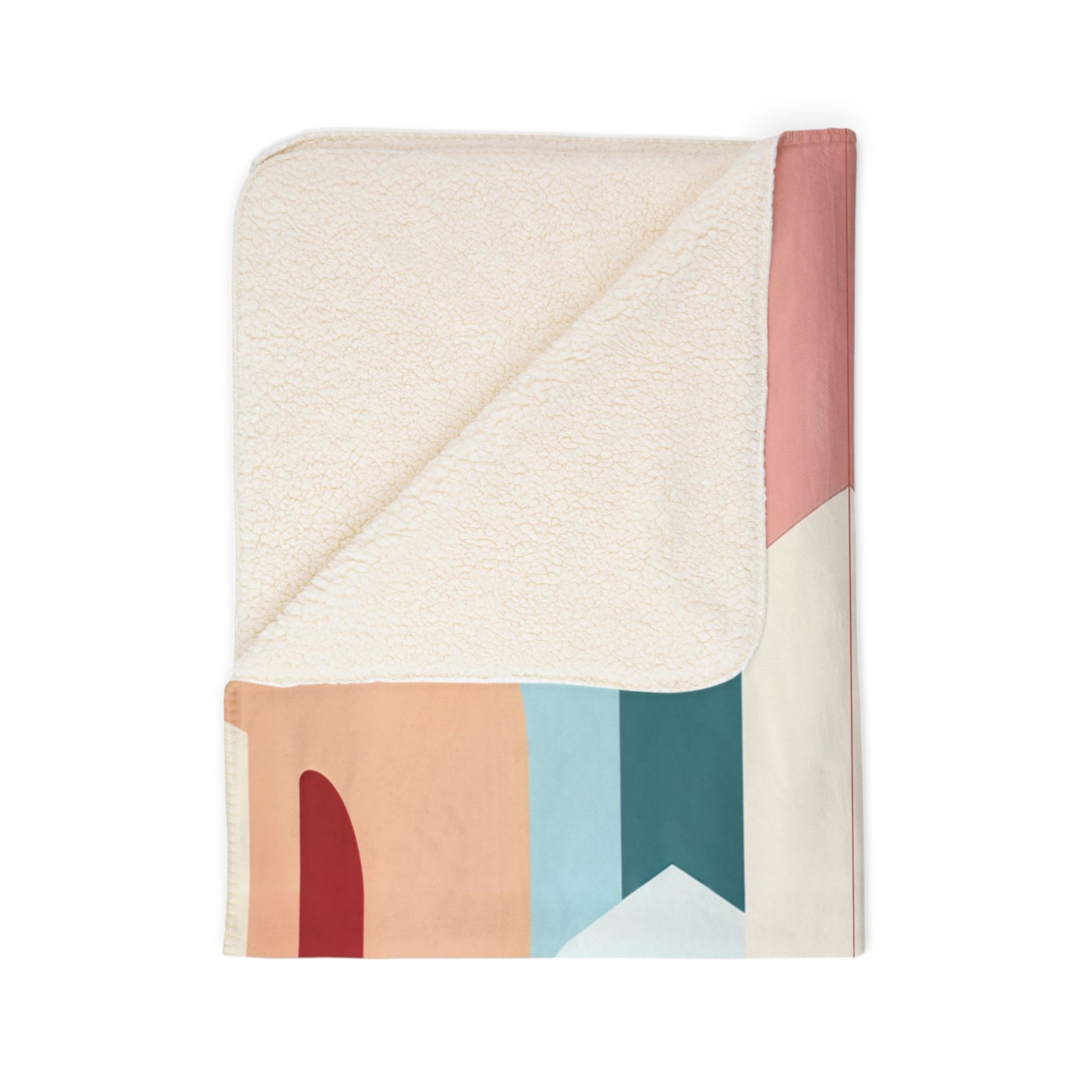 A folded rectangular blanket with a soft, cream-colored sherpa fleece on one side and an African-inspired geometric color block pattern on the other, featuring shades of peach, red, blue, teal, and off-white. Displayed on a plain white background.