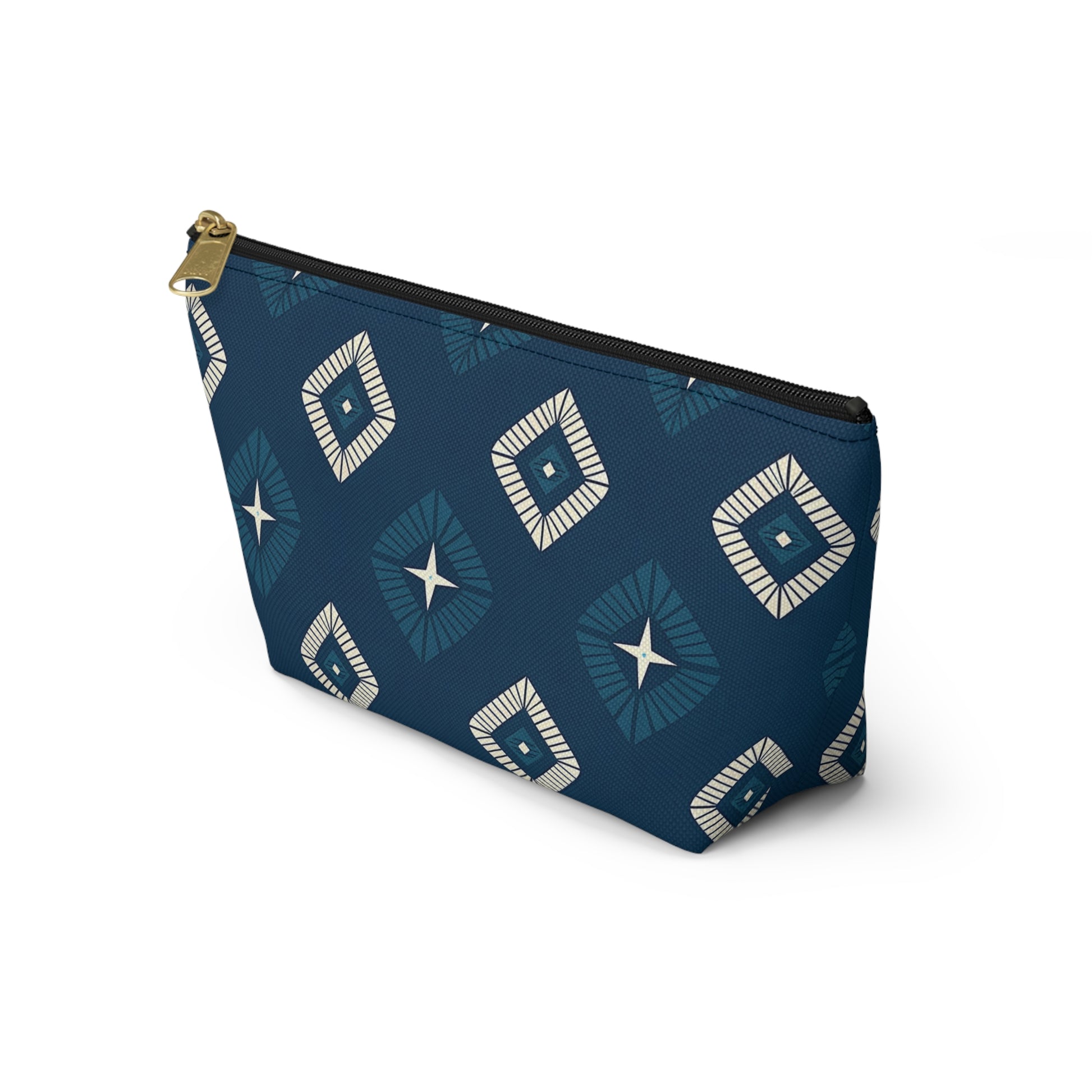 A T-bottom cosmetic travel bag with a black zipper and gold pull. The blue pouch showcases African-inspired patterns of white and blue diamond shapes, each with a central star, arranged in a repeating geometric design.