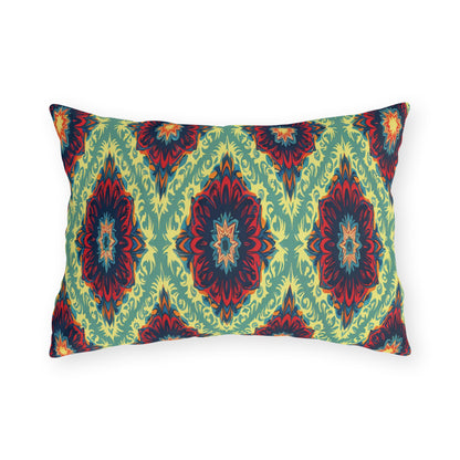 Rectangular pillow with a bold African-inspired geometric pattern in red, navy blue, and orange on a light green background. The symmetrical diamond and starburst design creates a vibrant, modern, and decorative look against the plain white backdrop.