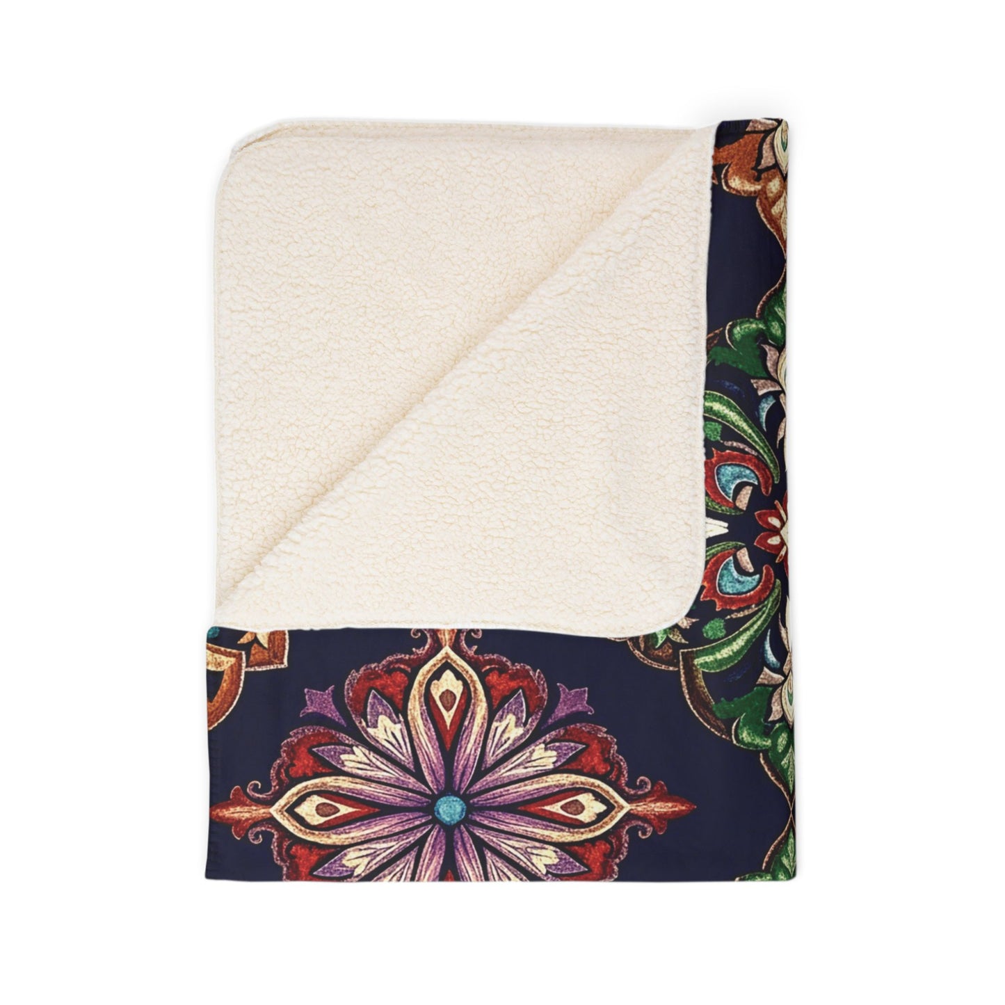 A folded sherpa-backed fleece blanket with a cream-colored, soft lining and dark exterior featuring a vibrant, symmetrical floral mandala in red, purple, green, and gold. One corner is turned down—perfect for cozy home decor.