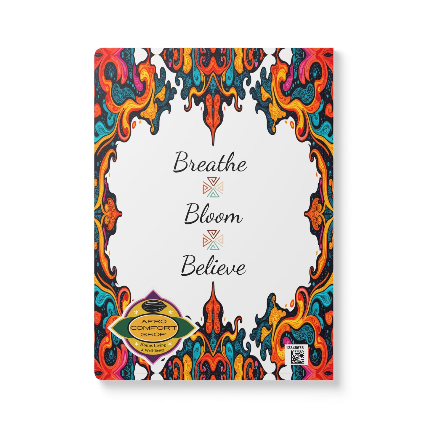 A creative journal cover featuring colorful, swirling abstract borders with a white center. "Breathe Bloom Believe" is elegantly scripted, evoking an African-inspired journal vibe. Gold Afro Comfort Shop badge and QR code complete the design.