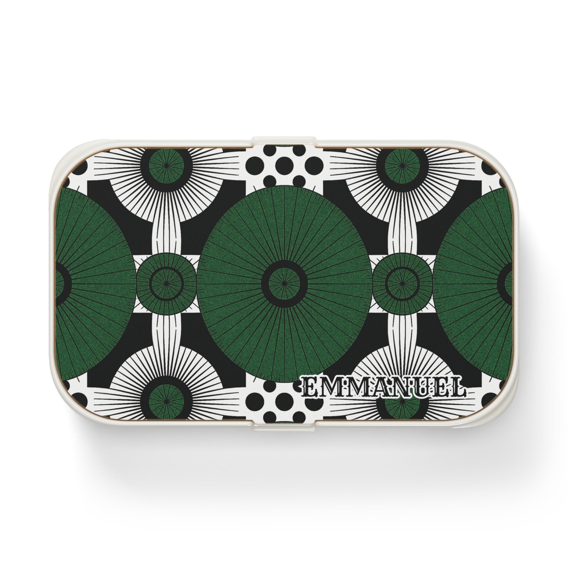 Rectangular custom lunch box with a geometric pattern of large green and black circular shapes and black dots on a white background. The bold, symmetrical design is personalized with EMMANUEL in serif letters in the lower right corner.
