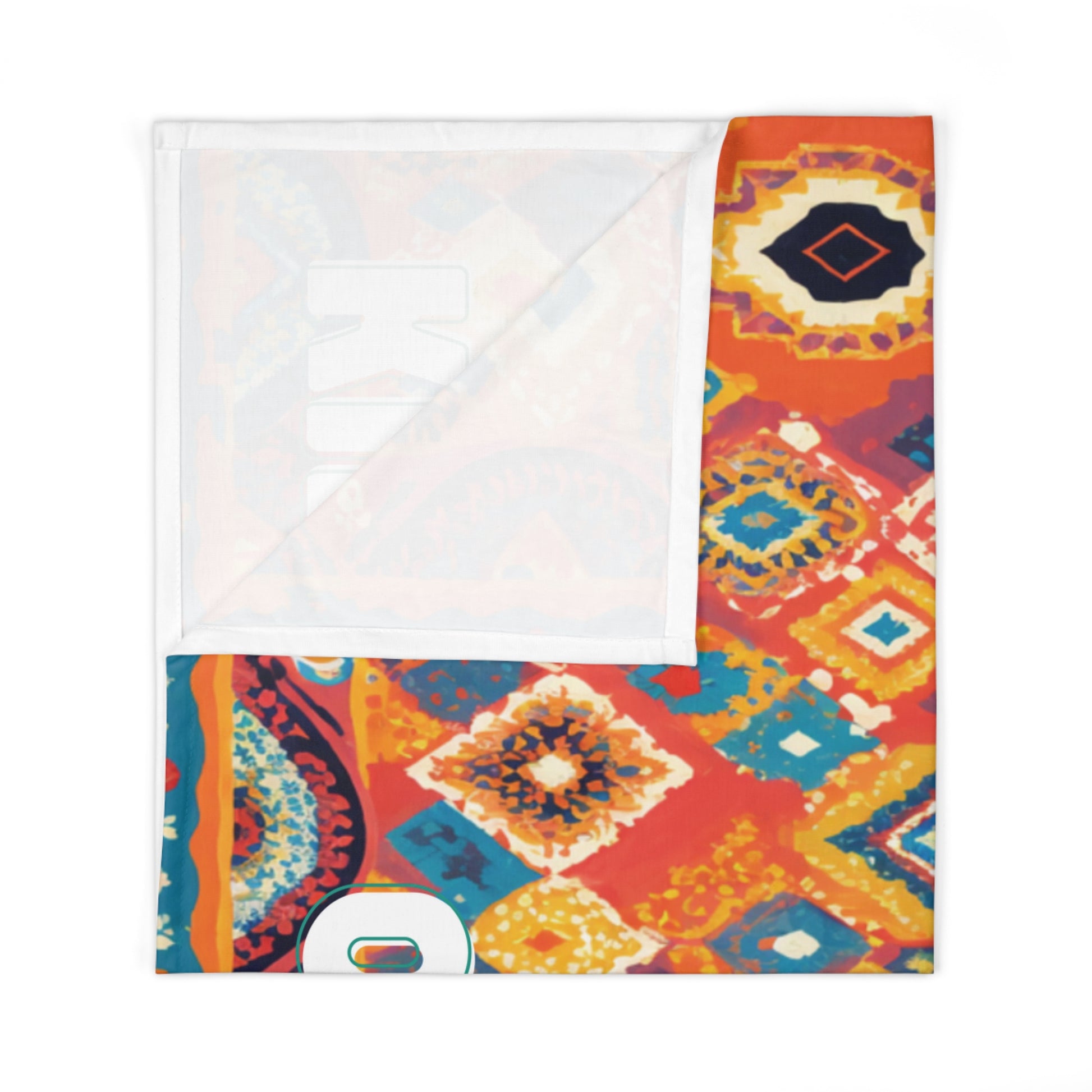 A folded blanket with a vibrant, multicolored geometric pattern in shades of orange, yellow, blue, and white adds an African-inspired decor touch. One corner is flipped over, revealing a plain white underside.