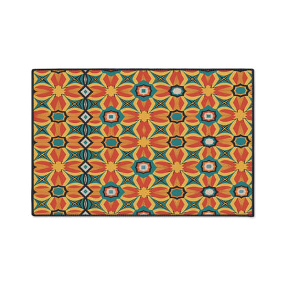 A rectangular mat with a vibrant, African-inspired geometric pattern featuring repeating star and flower shapes in bold, colorful mosaic tones. The symmetrical design includes diamond shapes forming a vertical line and a non-slip rubber backing.