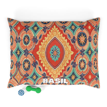 A cozy pet pillow featuring a vibrant, multicolored mandala pattern and “BASIL” in white at the bottom center. Two dog toys—a blue ball and green bone—add playful charm to this stylish pet bed on a crisp white background.