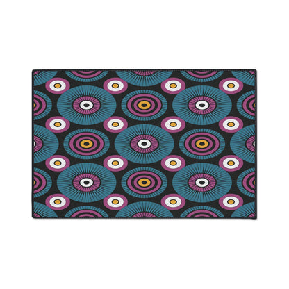 A rectangular custom floor mat featuring a repeating geometric pattern of concentric circles in blue, purple, white, yellow, and red on a black background for an African-inspired, vibrant, eye-catching, and symmetrical design.