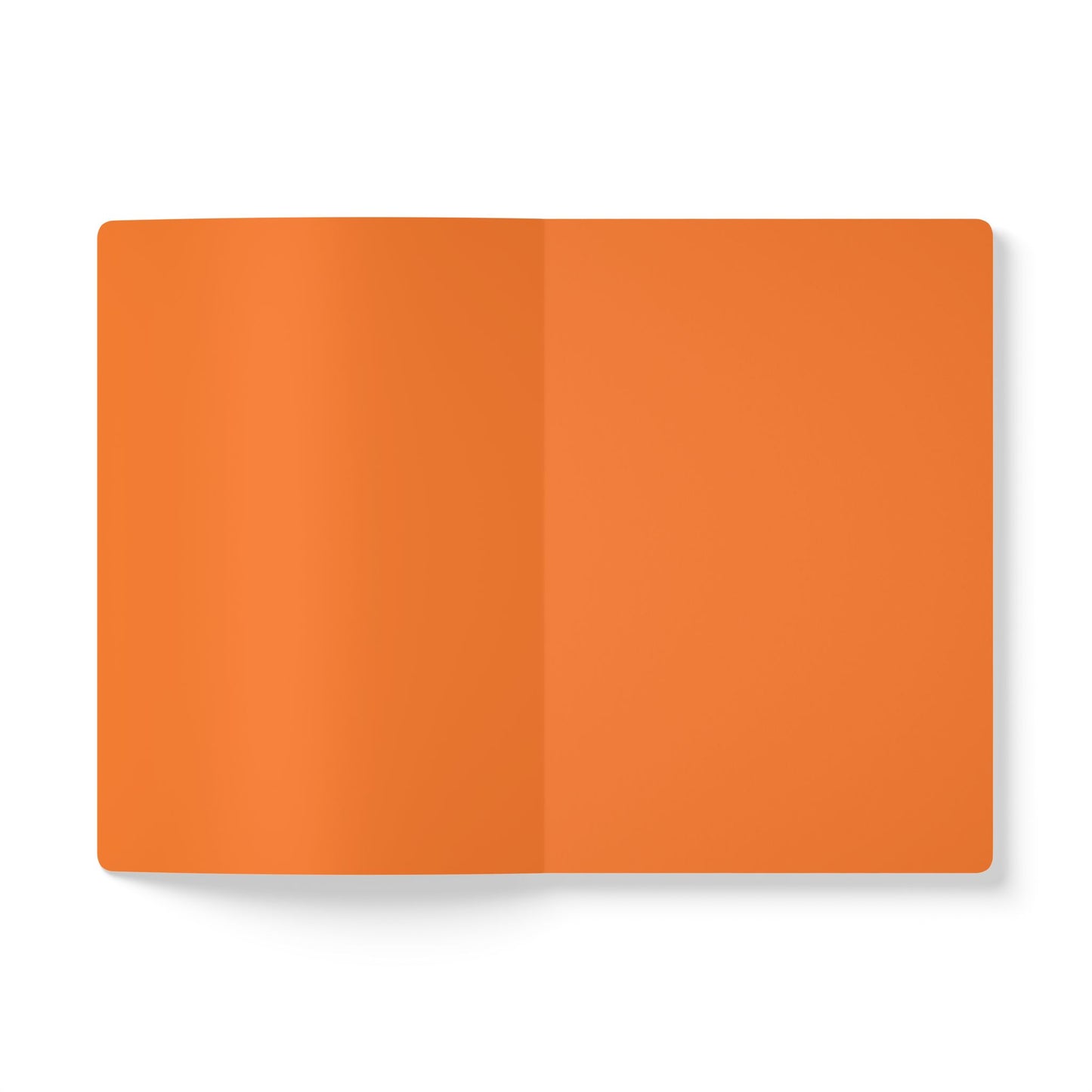 An open, blank creative journal with orange pages lies on a white surface. The notebook is viewed from above, showing the center crease and smooth, unmarked pages, perfect for daily journaling, with a subtle shadow on the left side.