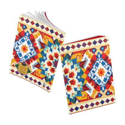 Two notebooks with colorful, geometric, and symmetrical patterns in red, blue, yellow, and white. The covers, reminiscent of an African-inspired journal, feature diamond and star shapes. Both notebooks are slightly open, showing white pages inside.