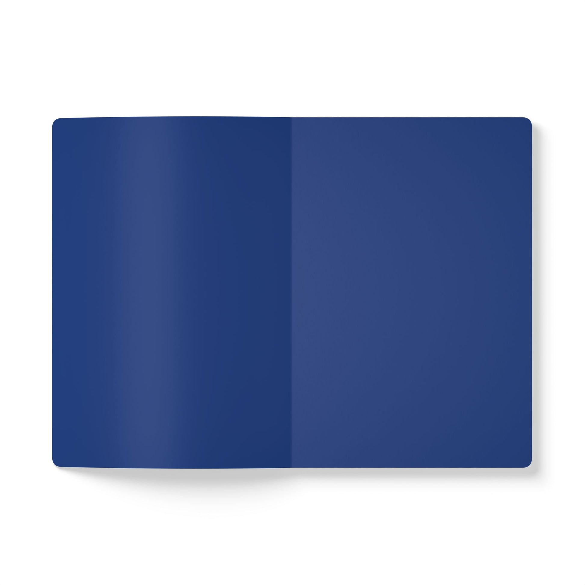 An open, blank notebook is shown from above against a white background. Both visible pages are solid dark blue, perfect for daily journaling or as a creative journal. The notebook casts a faint shadow to the left.