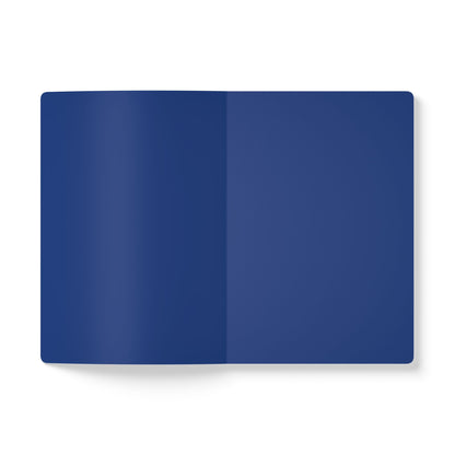 An open, blank notebook is shown from above against a white background. Both visible pages are solid dark blue, perfect for daily journaling or as a creative journal. The notebook casts a faint shadow to the left.