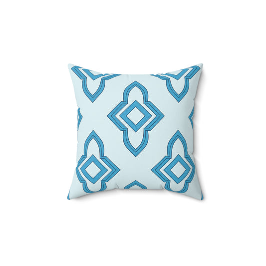 A square faux suede pillow with a geometric pattern in shades of blue on a light blue background. Interconnected diamond and pointed shapes create a modern, symmetrical look—perfect as an African accent pillow for any space. Pillow is centered on plain white.