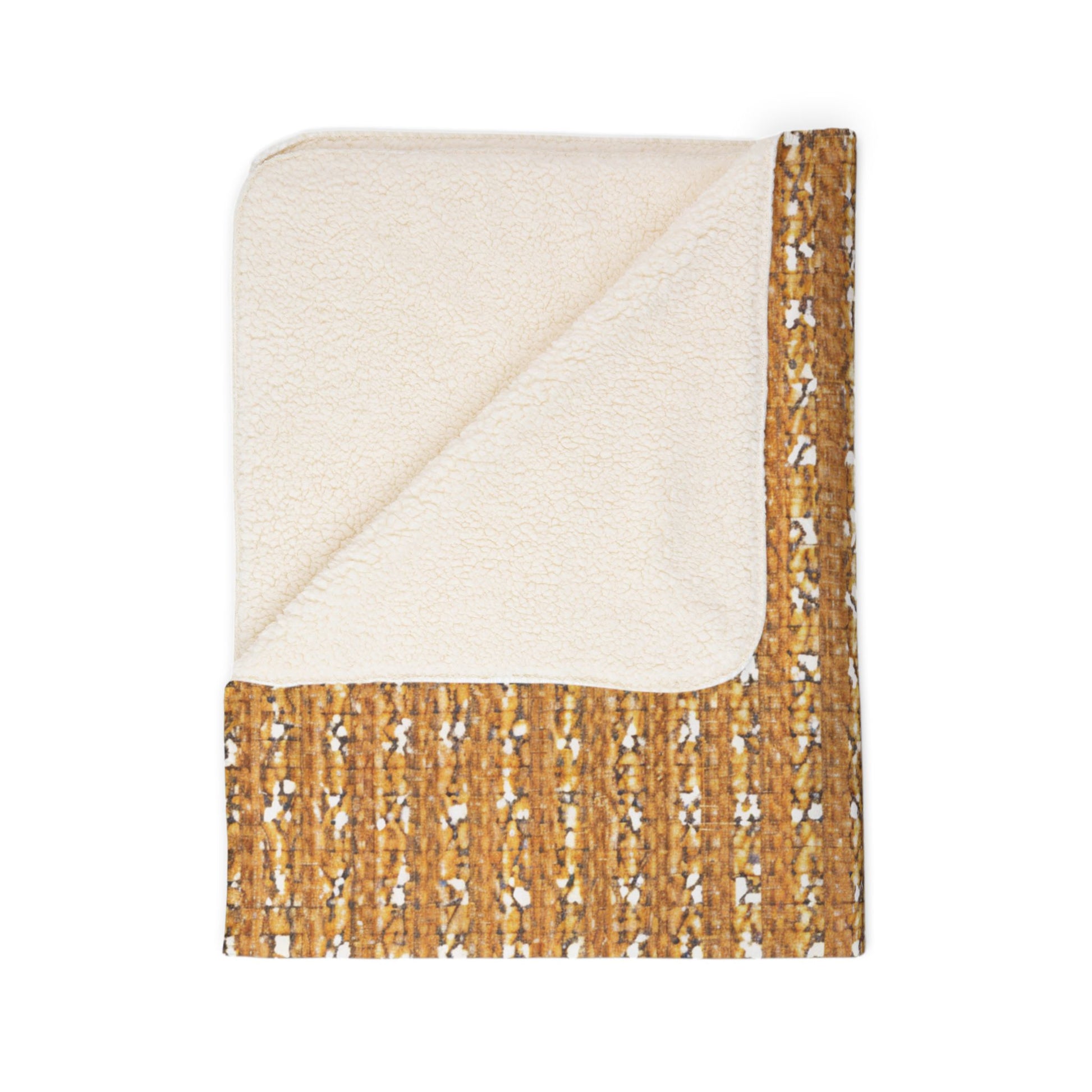 A folded sherpa fleece blanket with one corner turned down. One side is cream-colored and fleece-like, while the other features a mustard yellow, brown, and white geometric pattern—perfect for cozy home decor. Displayed on a white background.