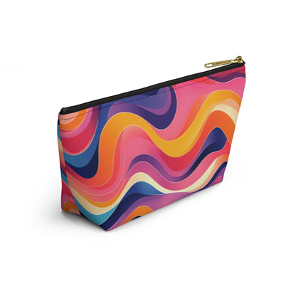 A zippered T-bottom pouch with a gold zipper, featuring a vibrant wavy pattern inspired by African-inspired patterns in orange, pink, yellow, purple, and blue. Perfect as a cosmetic travel bag, its bold lines create a dynamic abstract look against a white background.