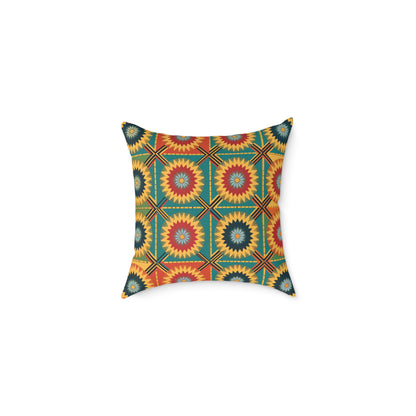 A decorative, African-inspired pillow with a vibrant geometric pattern. Hexagons filled with starburst shapes in red, yellow, and teal pop against a golden-yellow background, making this vibrant throw pillow perfect for colorful home decor.
