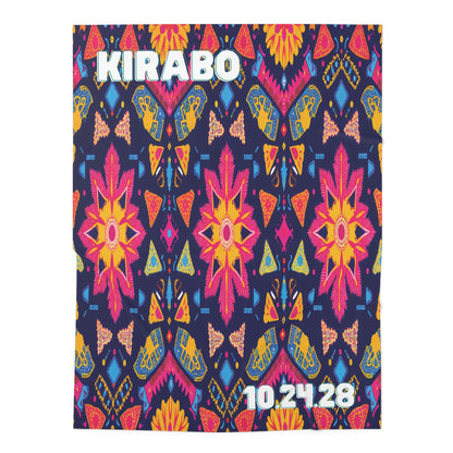 A colorful, symmetrical pattern featuring pink and orange flowers, yellow butterflies, and geometric shapes on a navy background—perfect as a personalized baby blanket or swaddle blanket for African-inspired decor. "KIRABO" is in bold white at the top left, “10.24.28” bottom right.