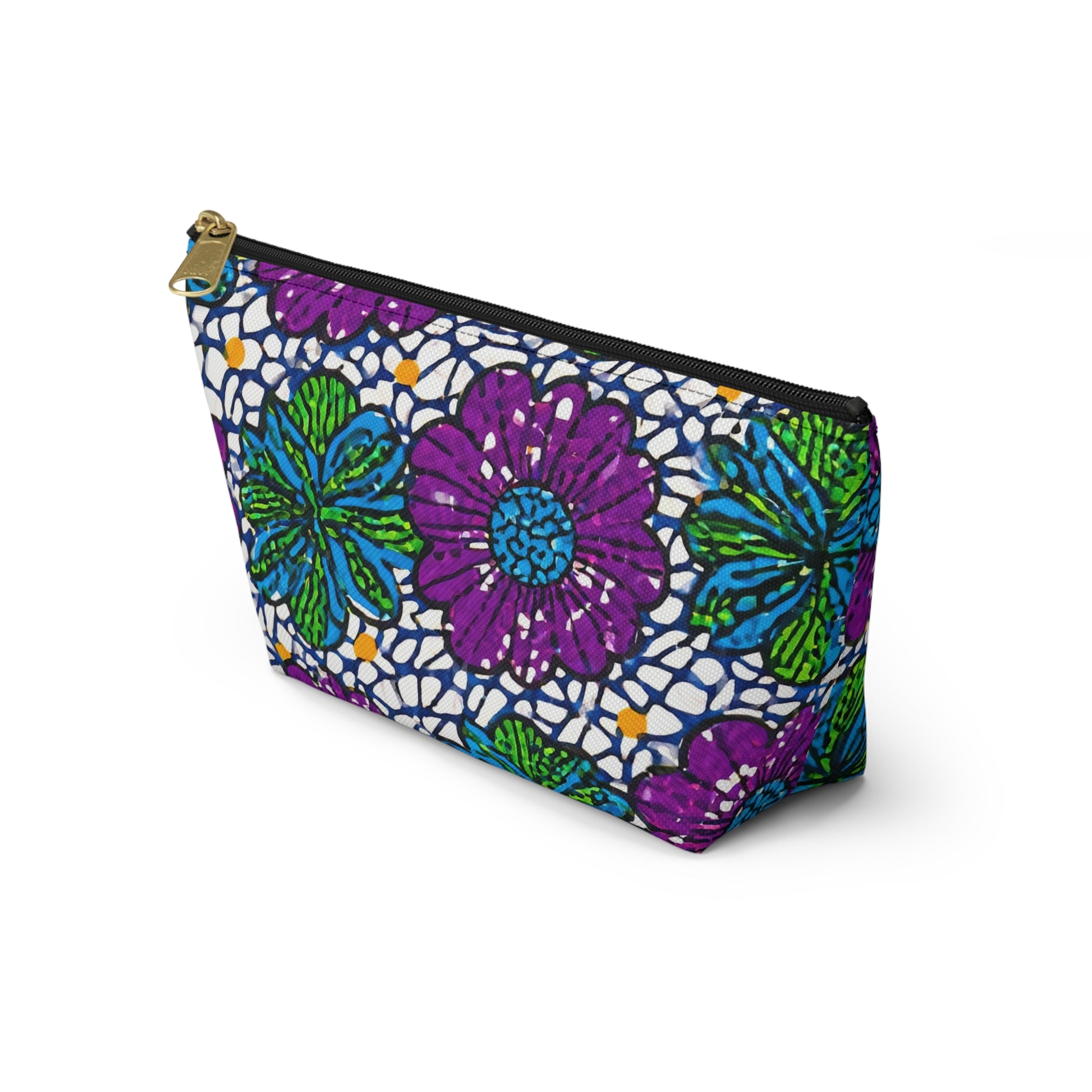 A zippered cosmetic travel bag with a bold, African-inspired floral pattern in purple, green, blue, and white. The large stylized flowers and gold zipper add flair to this T-bottom pouch, which stands upright against a plain white background.